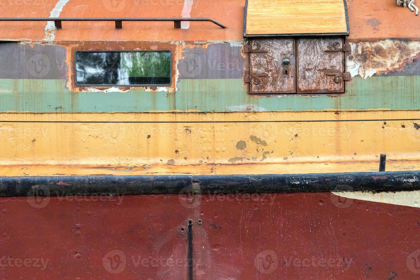 rusty rugged ship in thames river photo