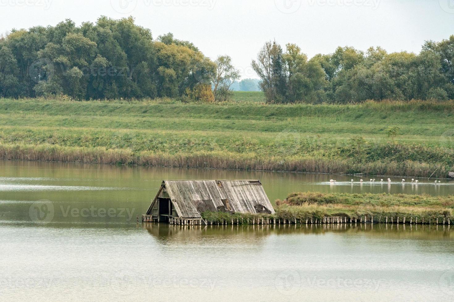 comacchio valley fisherman house on cloudy sky background photo