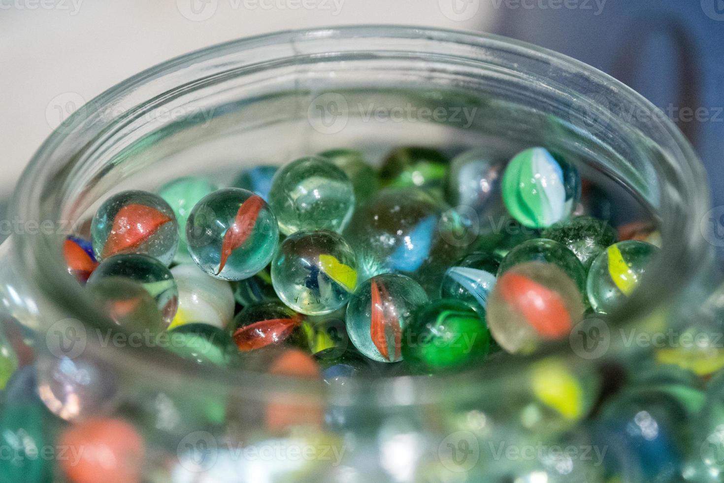 many small glass balls in a vase photo