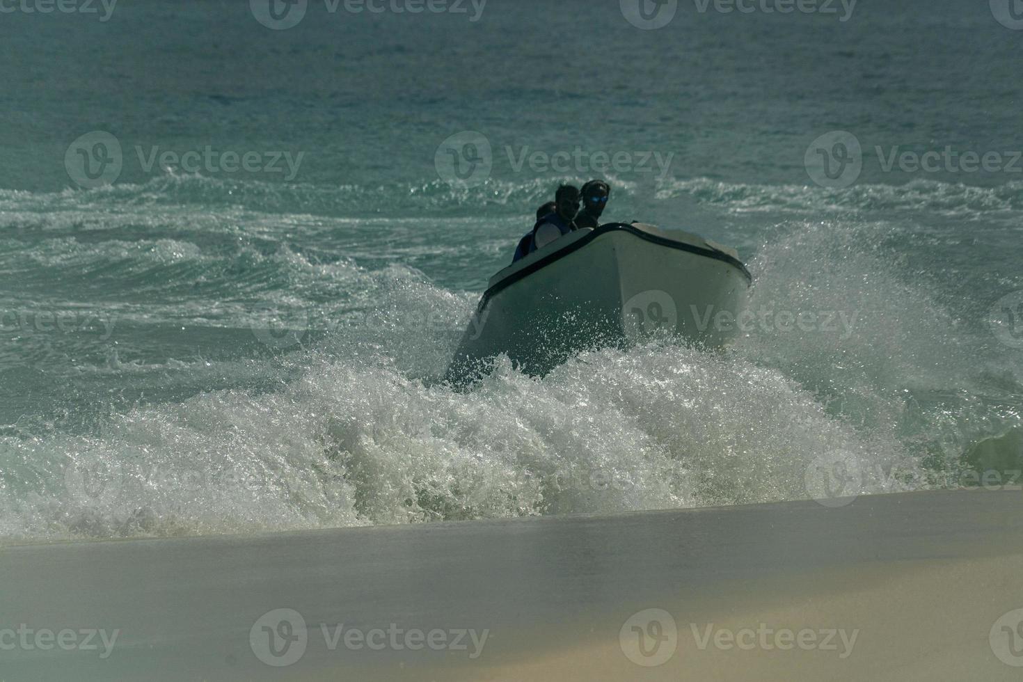 migrant boat landing on the beach photo