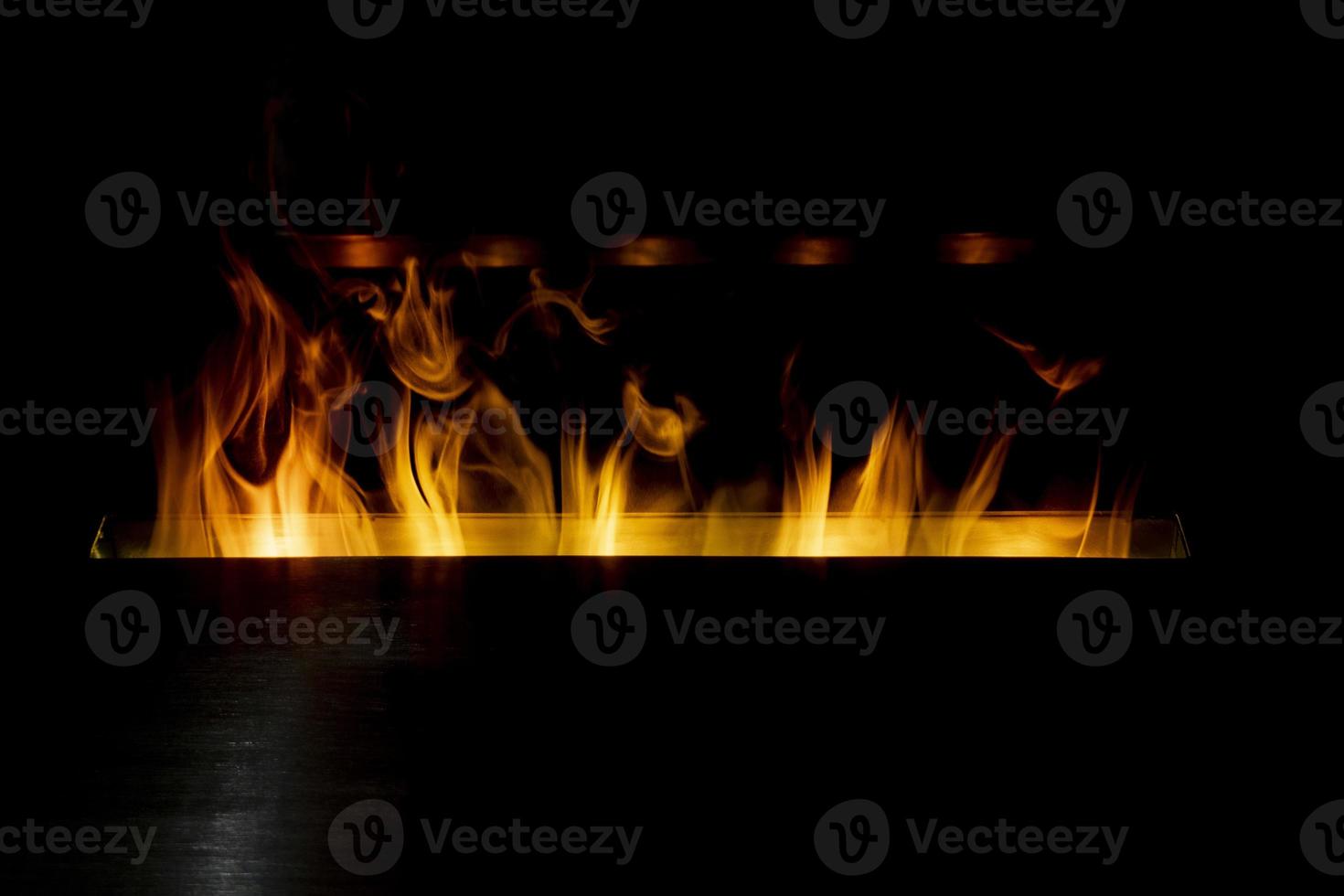 bioethanol fireplace detail flames on black background photo