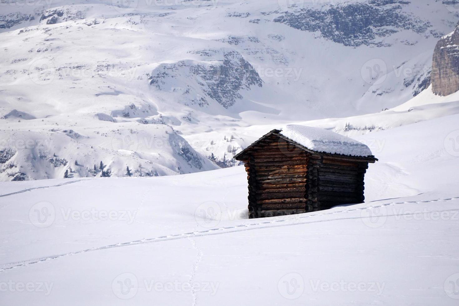 wood cabin hut in the winter snow background photo