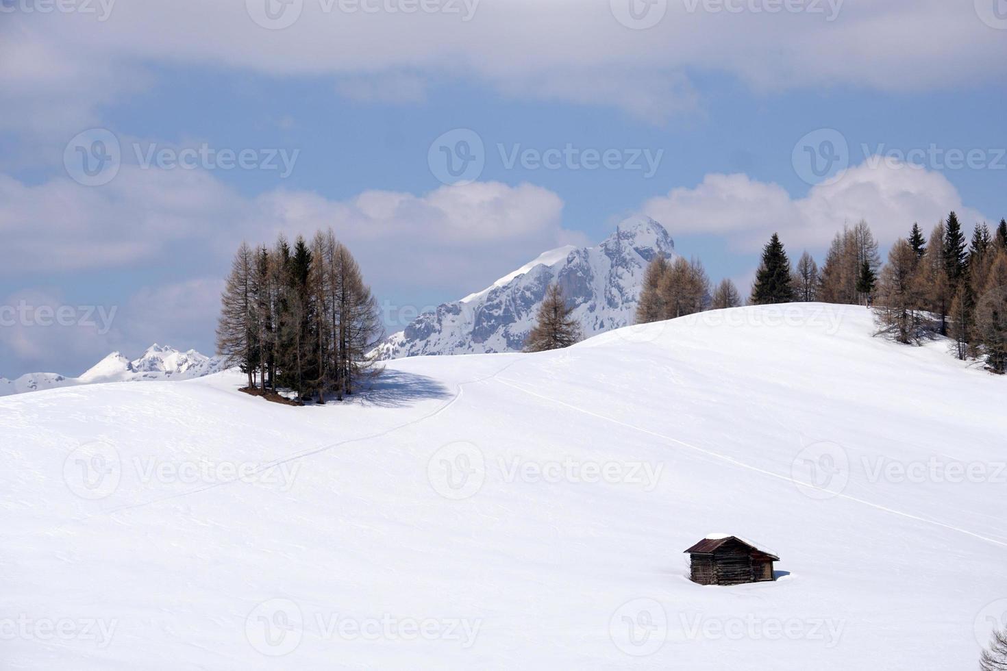 A wood cabin hut in the winter snow background photo