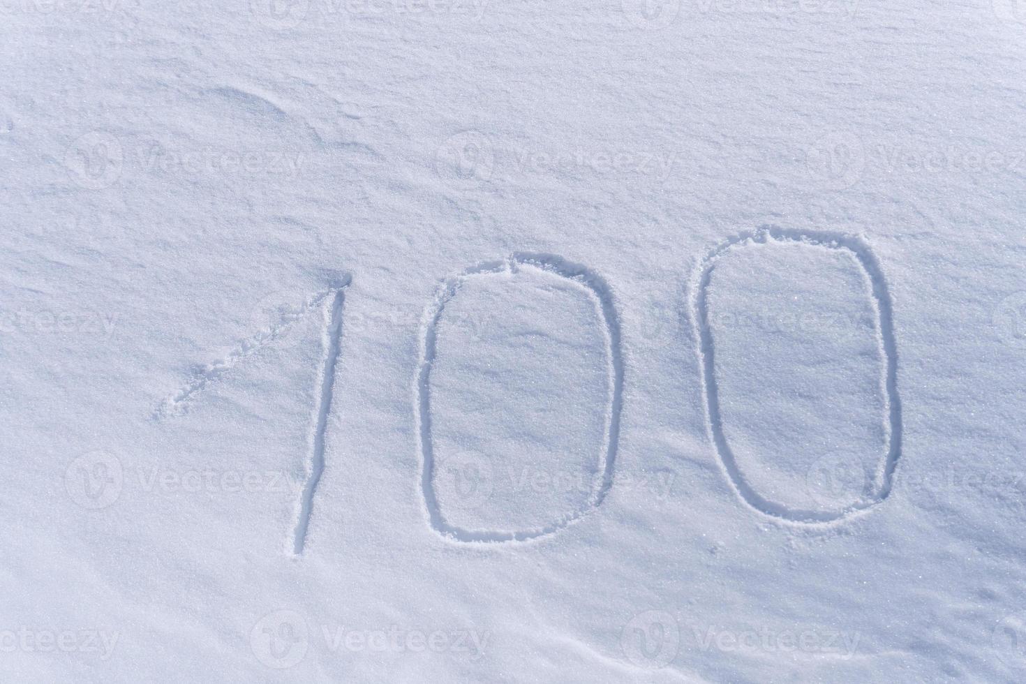 100 one hundred number writing on the snow photo