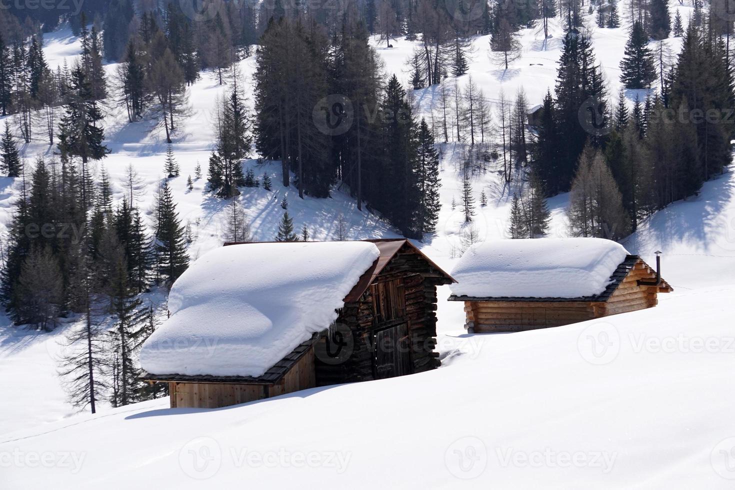 wood cabin hut in the winter snow background photo