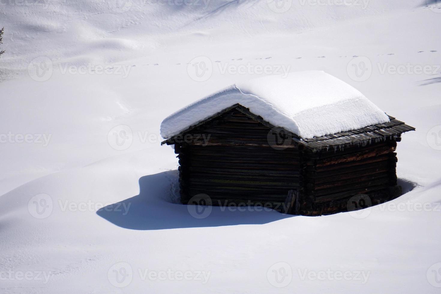 wood cabin hut in the winter snow background photo