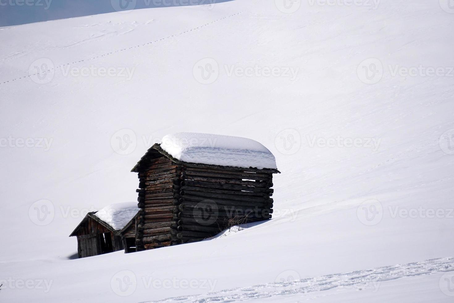 wood cabin hut in the winter snow background photo