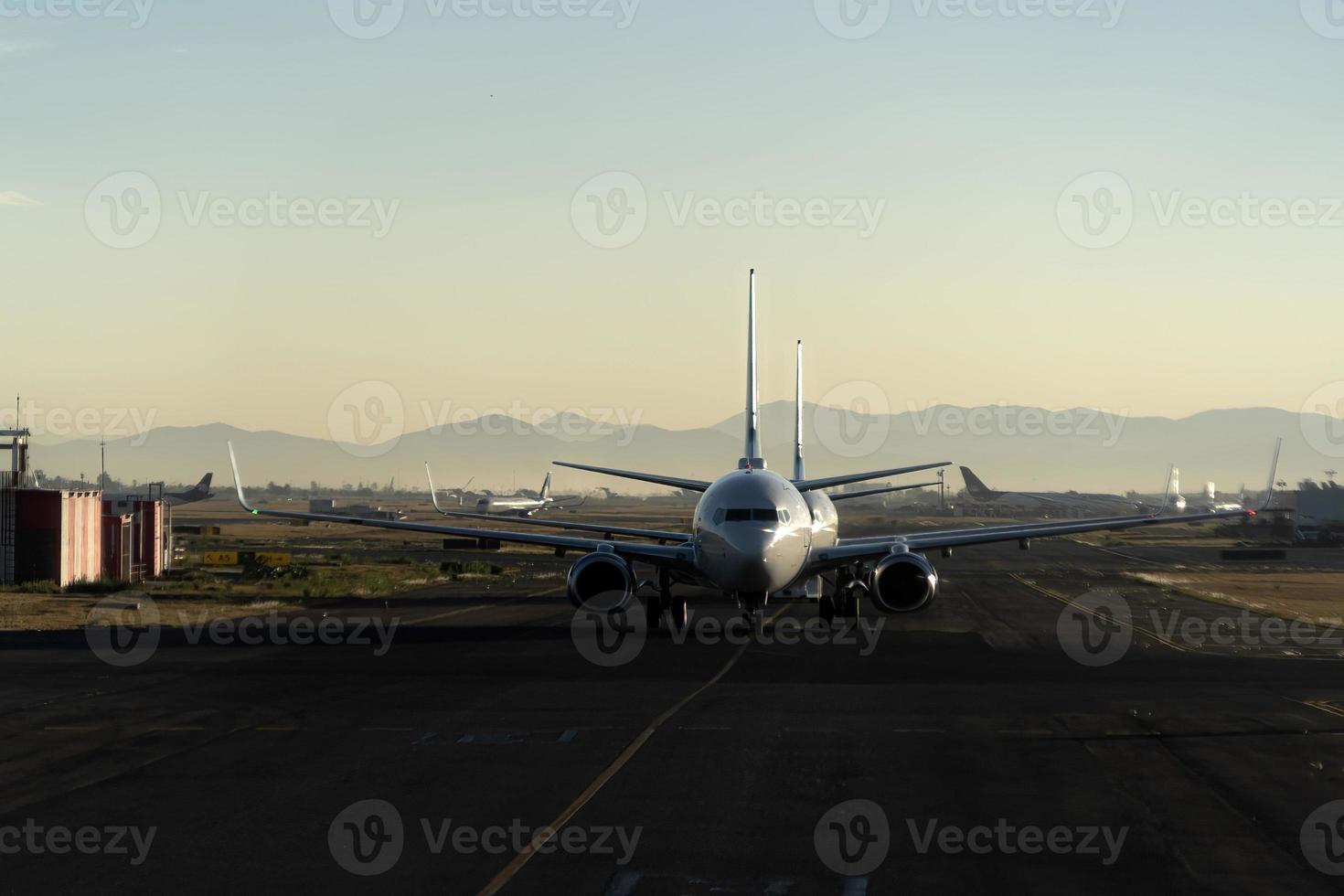 airplane queue before take off at sunset photo