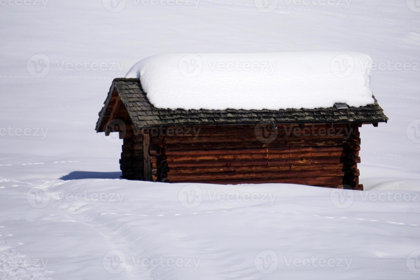 wood cabin hut in the winter snow background photo