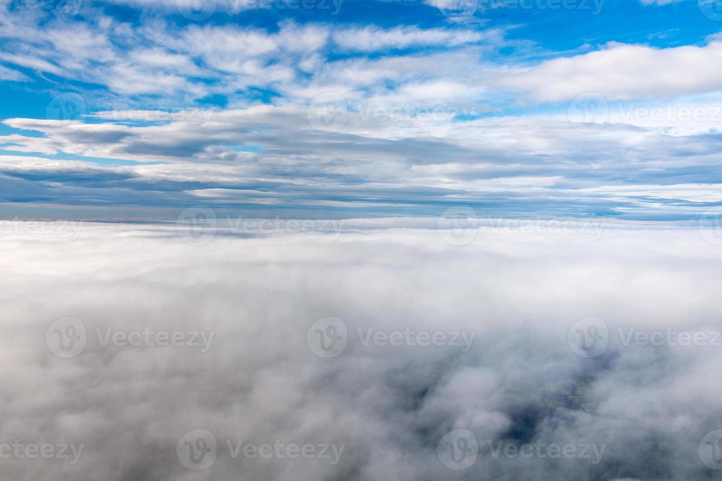 clouds in the sky from airplane window photo
