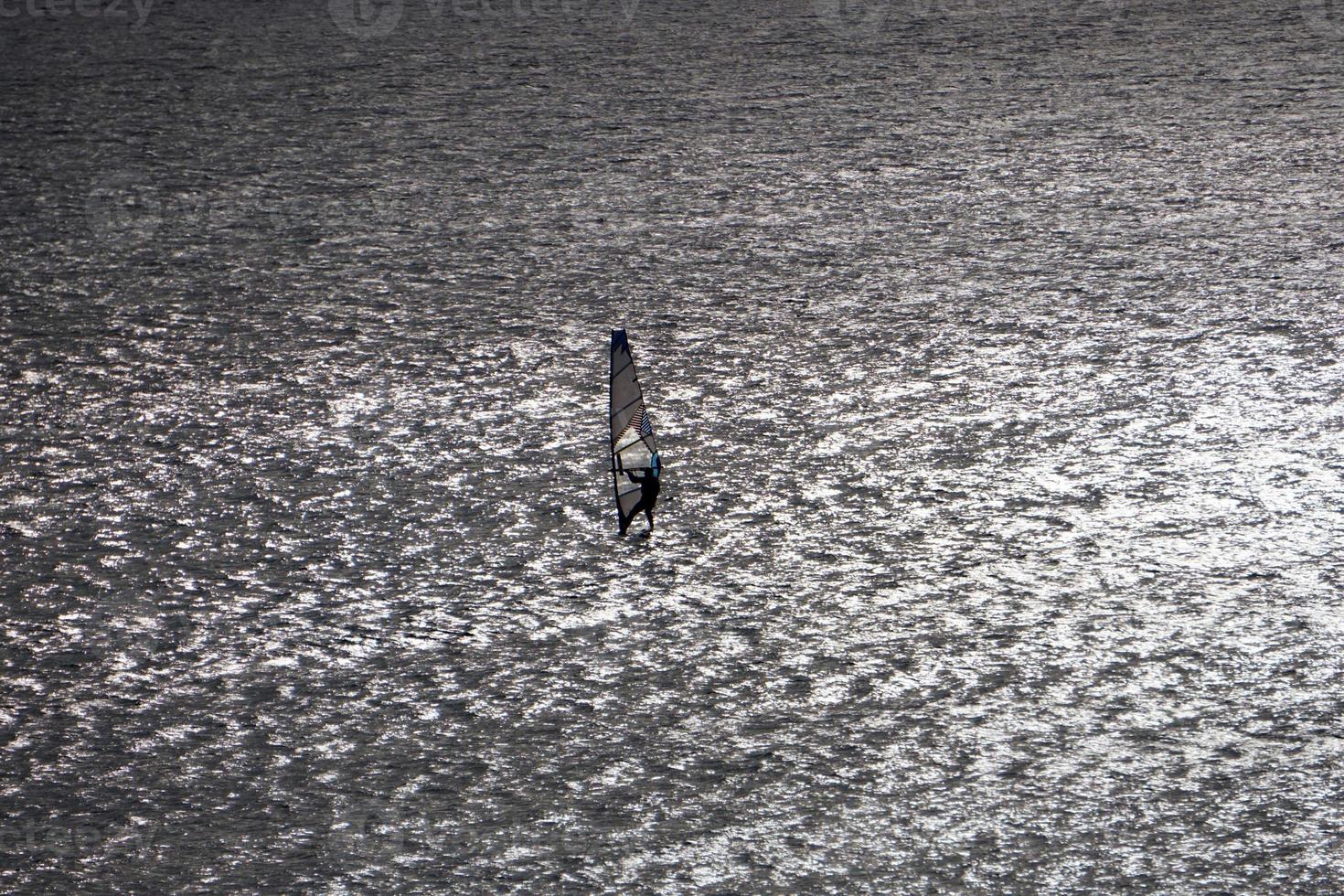 Windsurfer silhouette on the backlight photo