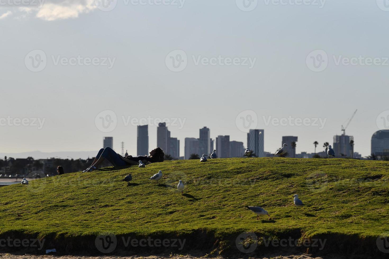 MELBOURNE, AUSTRALIA - AUGUST 14, 2017 - People relaxing on st. Kilda the beach photo