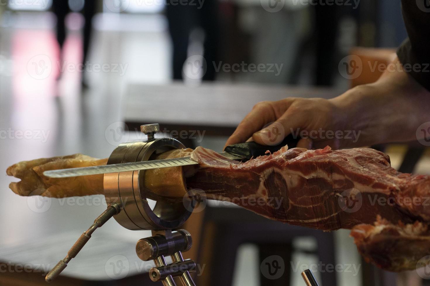 Hands while cutting spanish ham photo