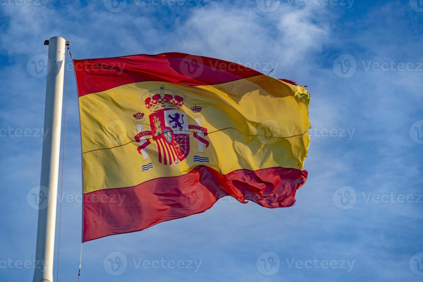 Waving spanish flag on sky photo