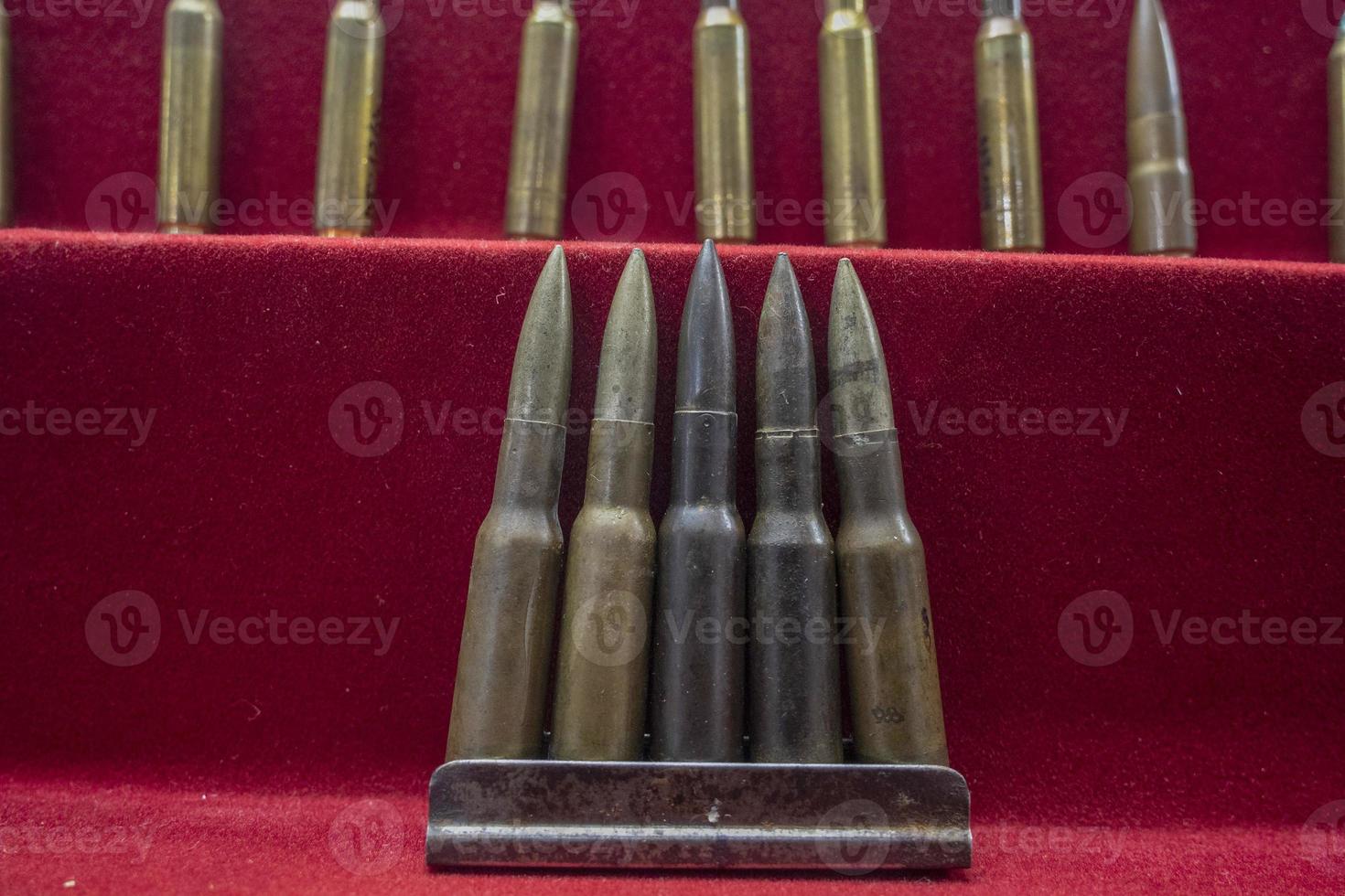 many war gun bullets close up on red photo