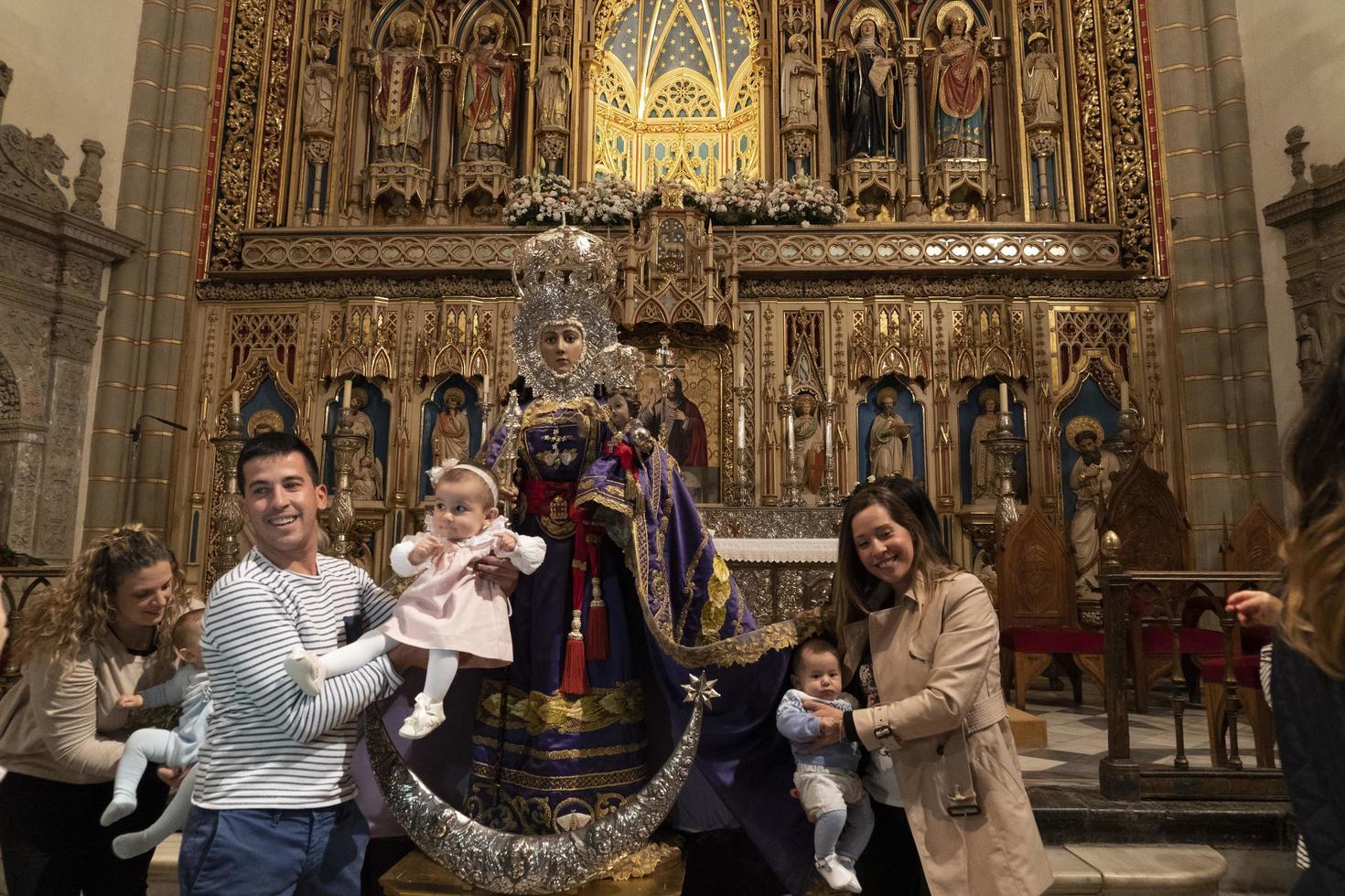 MURCIA, SPAIN - MARCH 25 2019 - Mother and sons waiting for blessing of Virgen de la Fuensanta photo