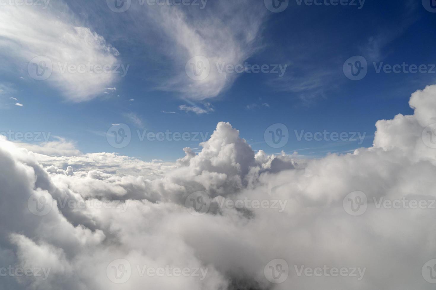 cloudy sky from airplane window while flying photo