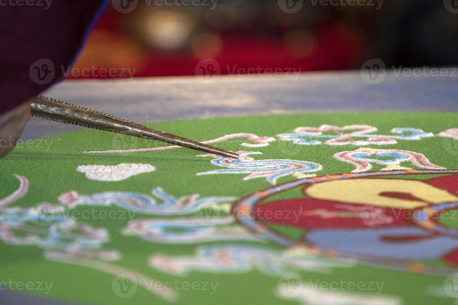 Tibetan monk mandala sand drawing photo