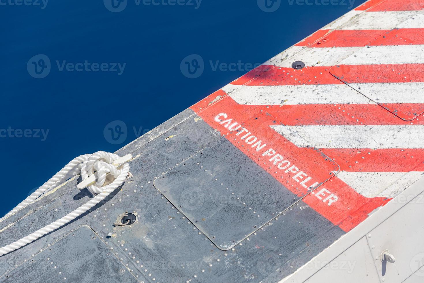 Propeller danger or warning sign on airplane with blue background photo