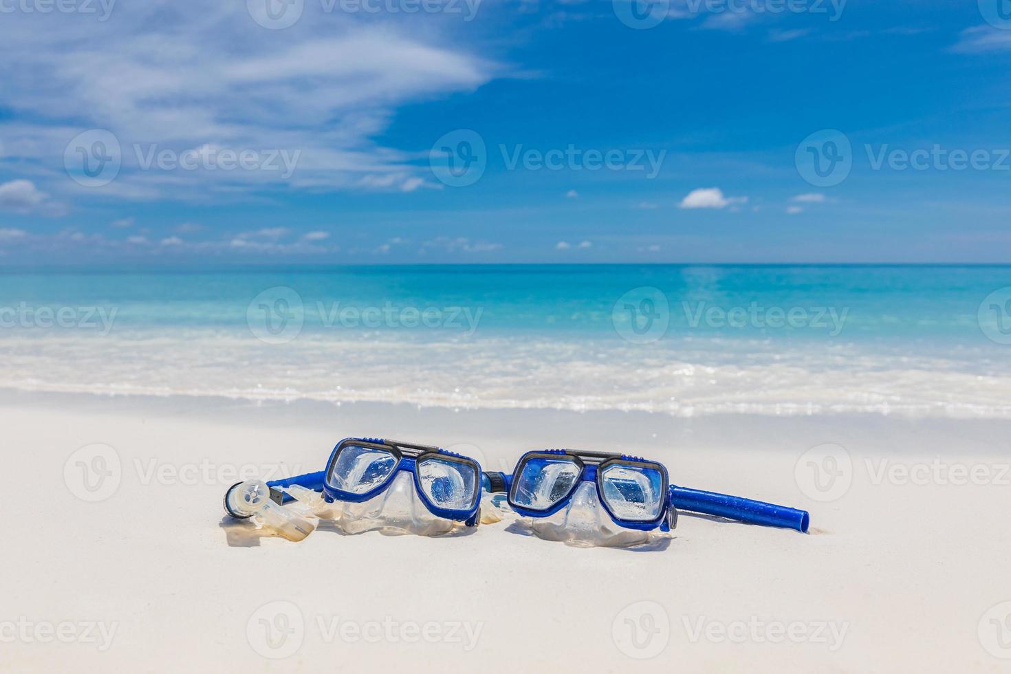 Summer beach coastline snorkel gear, googles on soft sand calm waves splashing. Tropical summer shore closeup, freedom adventure, outdoor recreation. Relaxing view of recreational activity, snorkeling photo