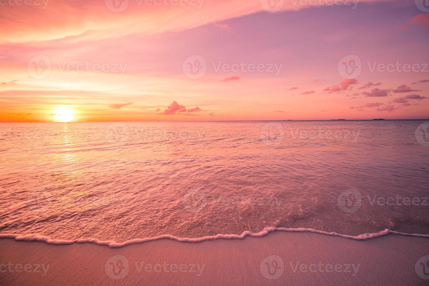 Dreamy beach scene with stunning waves. Colorful ocean beach sunrise or sunset, colorful bright sky and sun rays. Inspirational shoreline with soft tropical waves and relaxing mood. Peaceful, serene photo