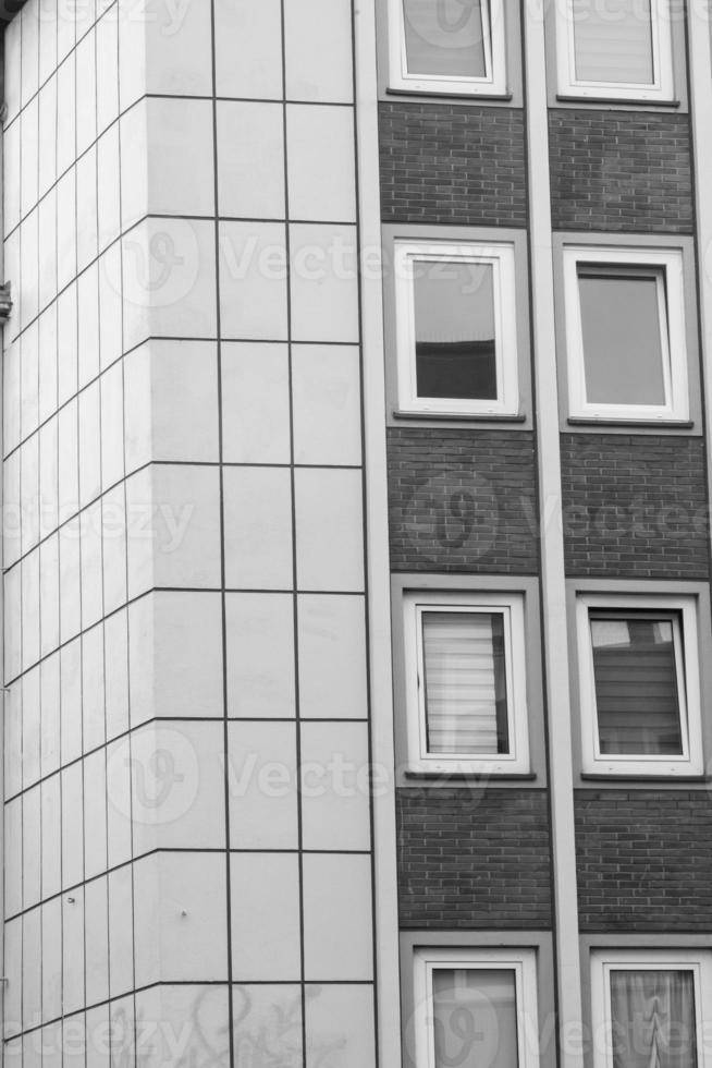 grayscale shot of a facade of modern building photo