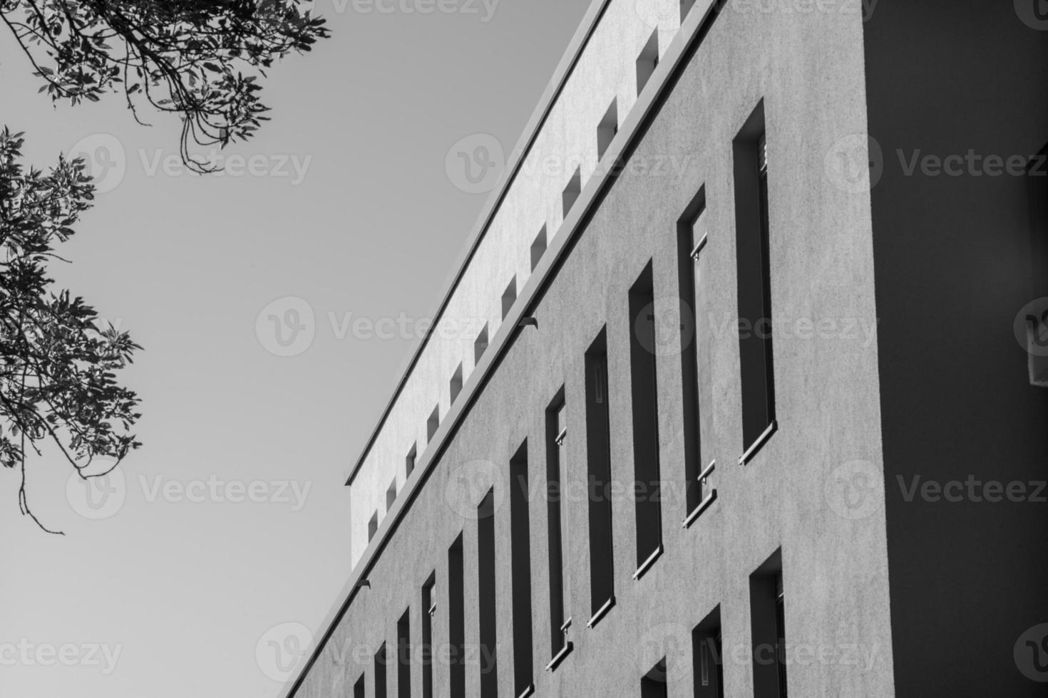 grayscale shot of a facade of modern building photo