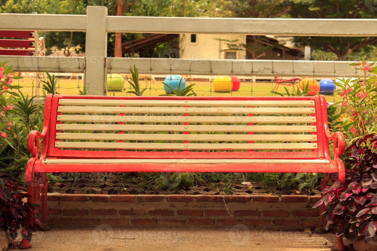 vintage chair that has been around for many years is set up to sit in the garden while relaxing, it is a beautiful garden decoration and the perfect combination of creative designers. photo