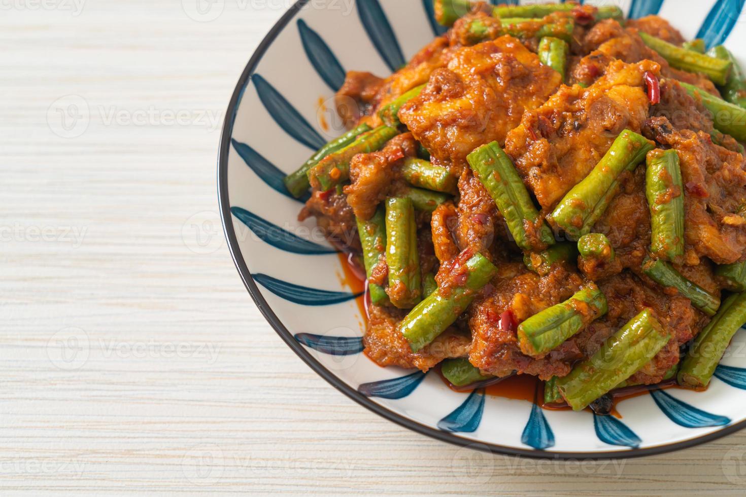 Stir fried pork with red curry paste photo