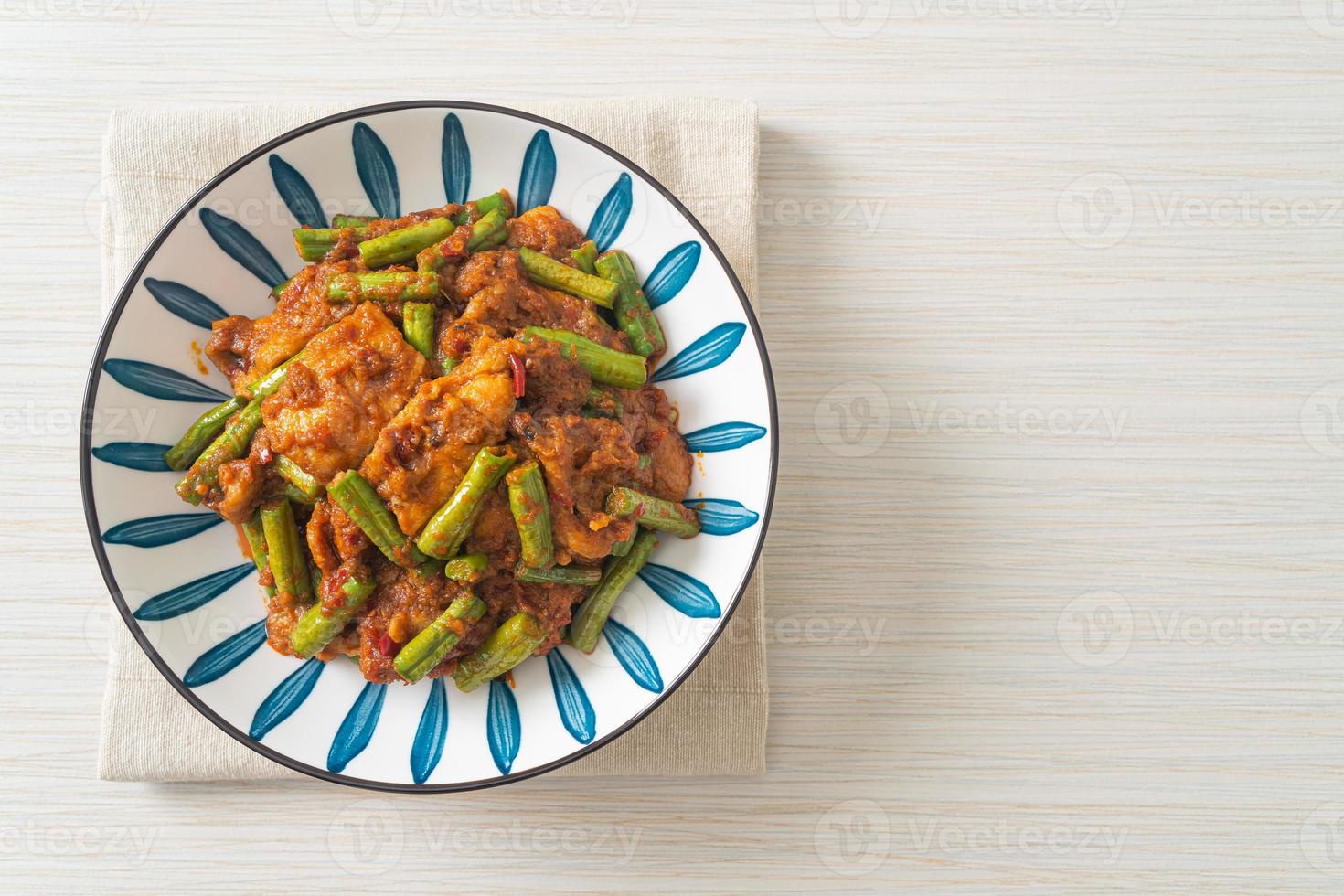 Stir fried pork with red curry paste photo