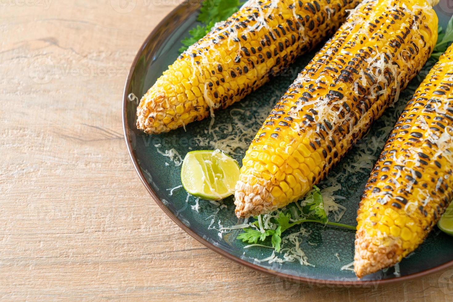 barbecue and grilled corn with cheese and lime photo