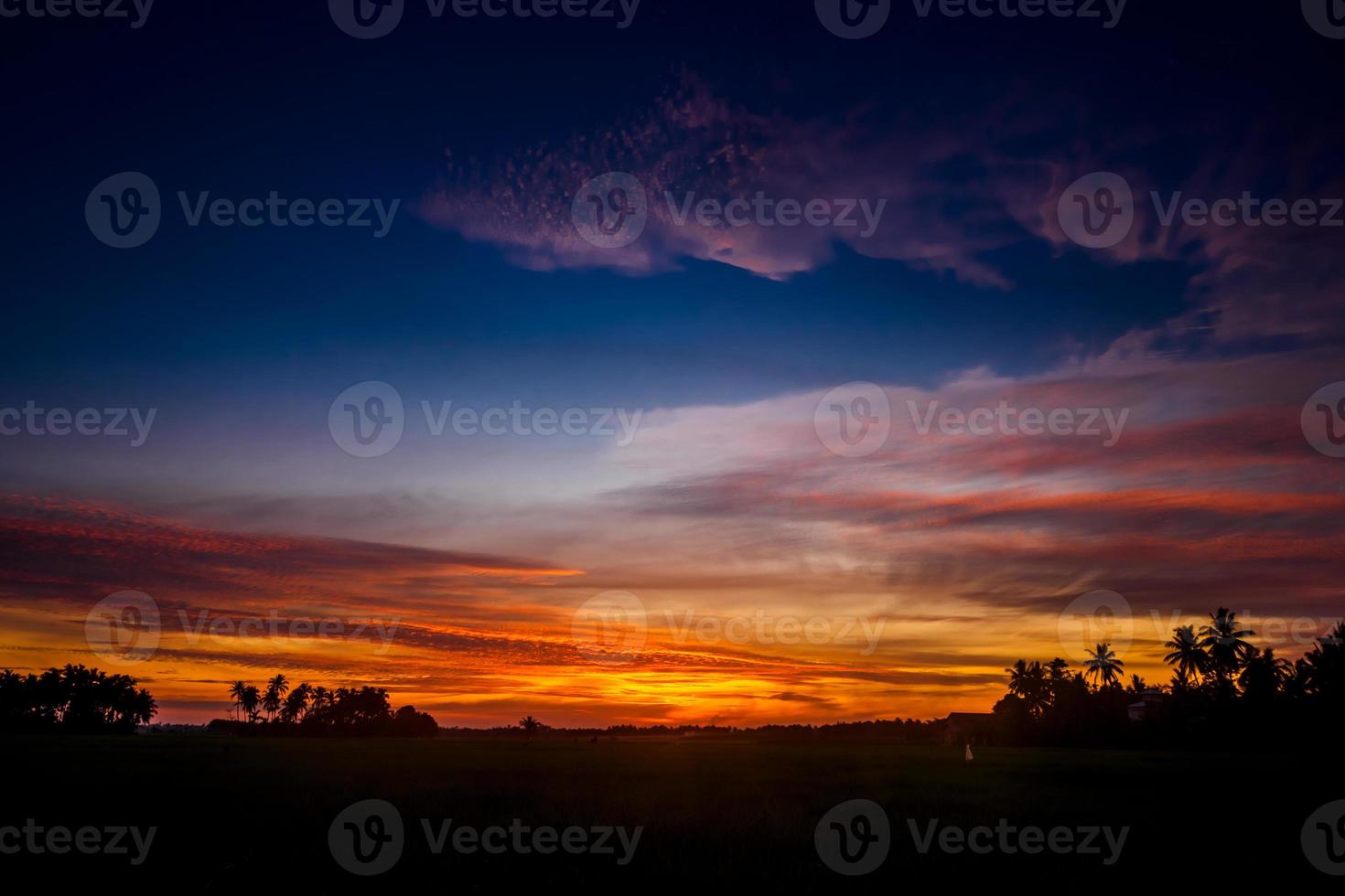 Beautiful evening sky at sundown over a village in Indonesia photo