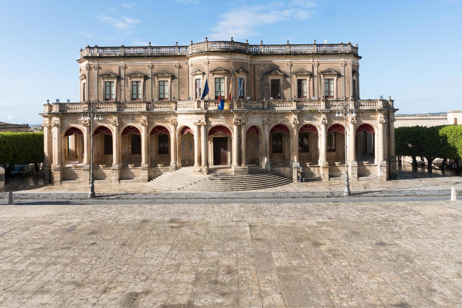 Noto,Italy-May 8, 2022-View of the Ducezio palace from from the top of the stairway of the Cathedral during a sunny day photo