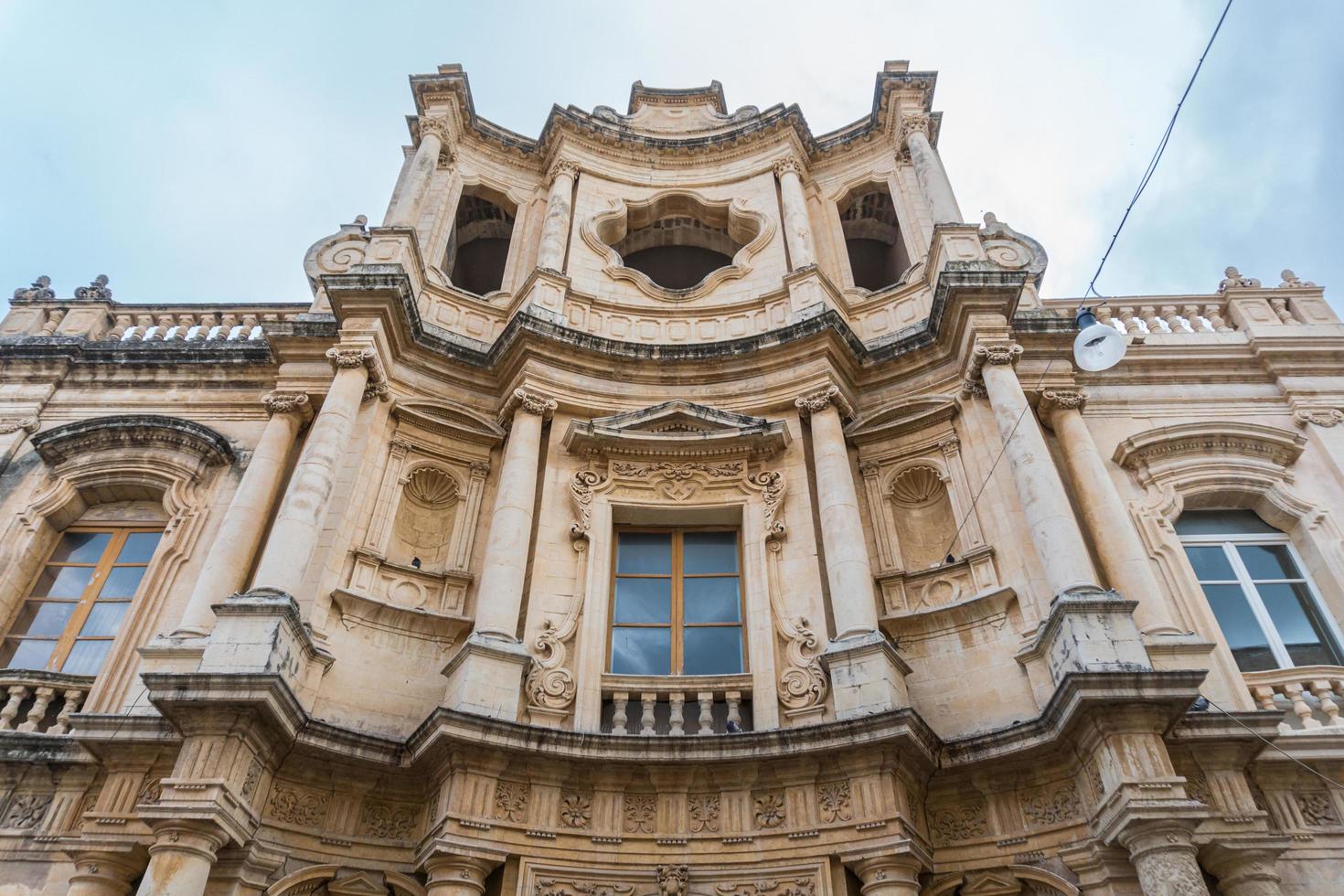 Noto,Italy-May 7, 2022-View of the Ducezio palace from from the top of the stairway of the Cathedral during a sunny day photo