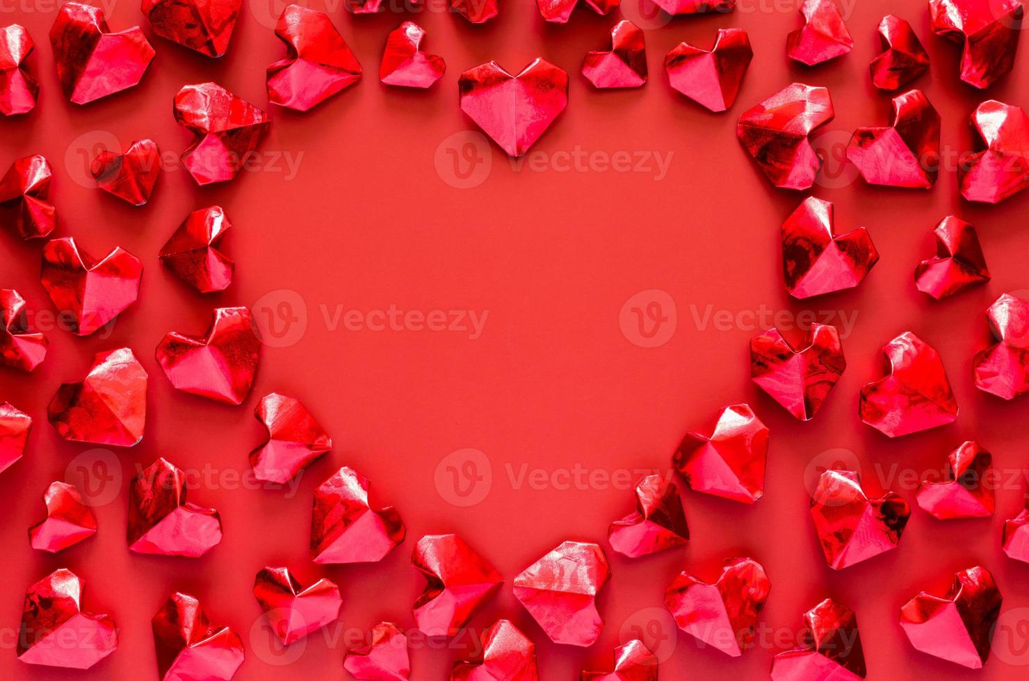 Red heart shape paper fold put on red background with love space for Valentines concept. photo