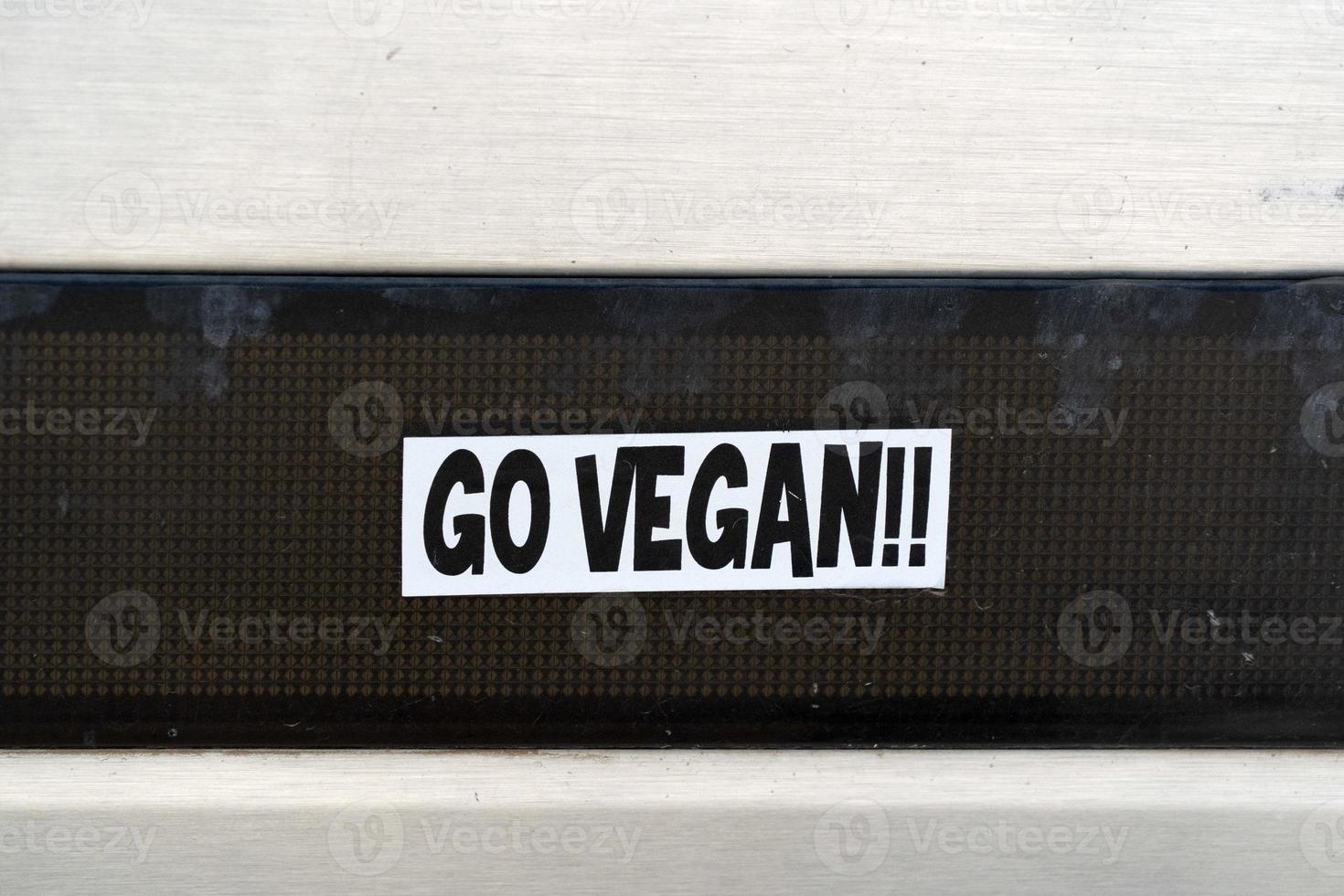 go vegan sticker on old car photo