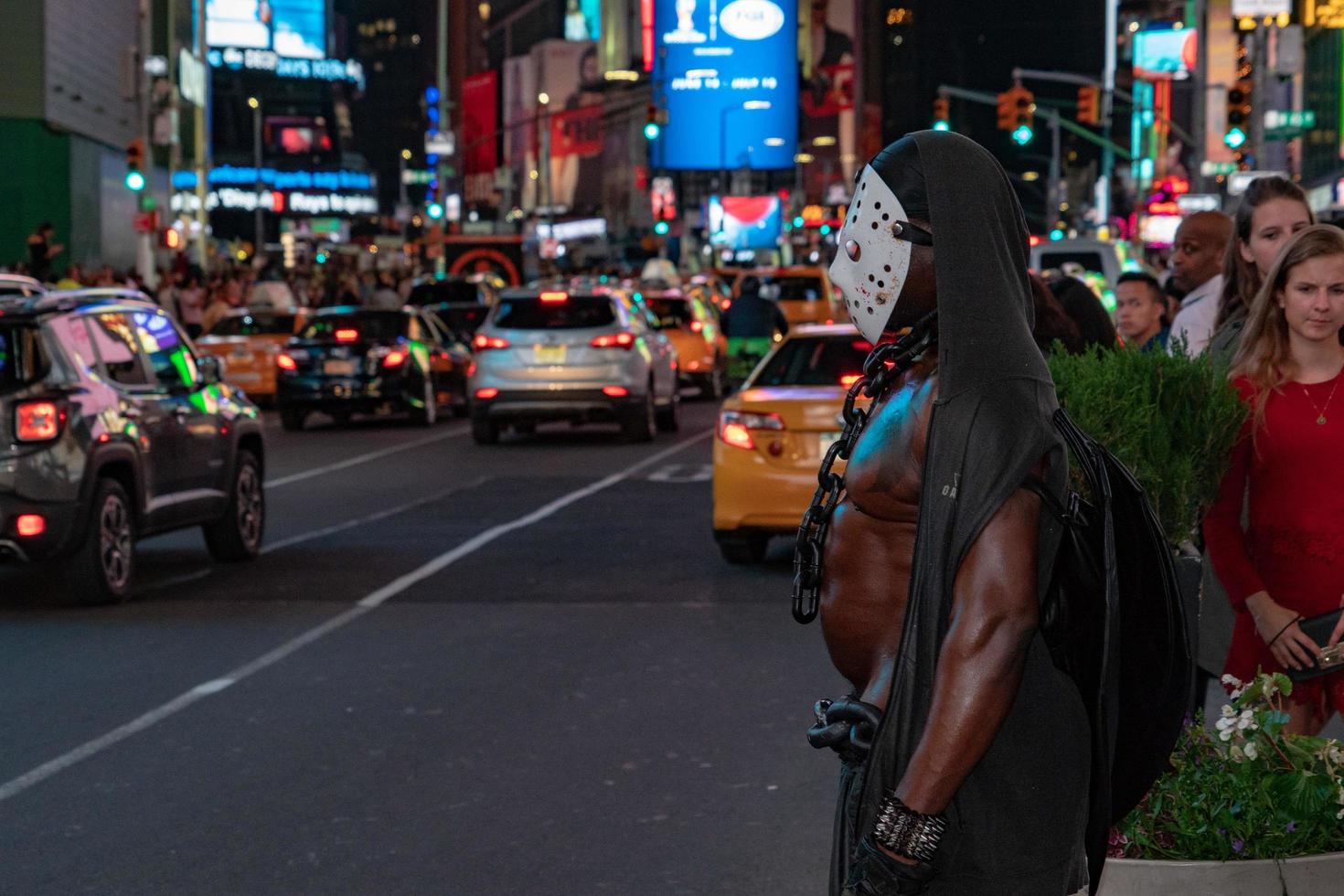 NEW YORK, USA - MAY 25 2018 - masked black man in Times square full of people photo