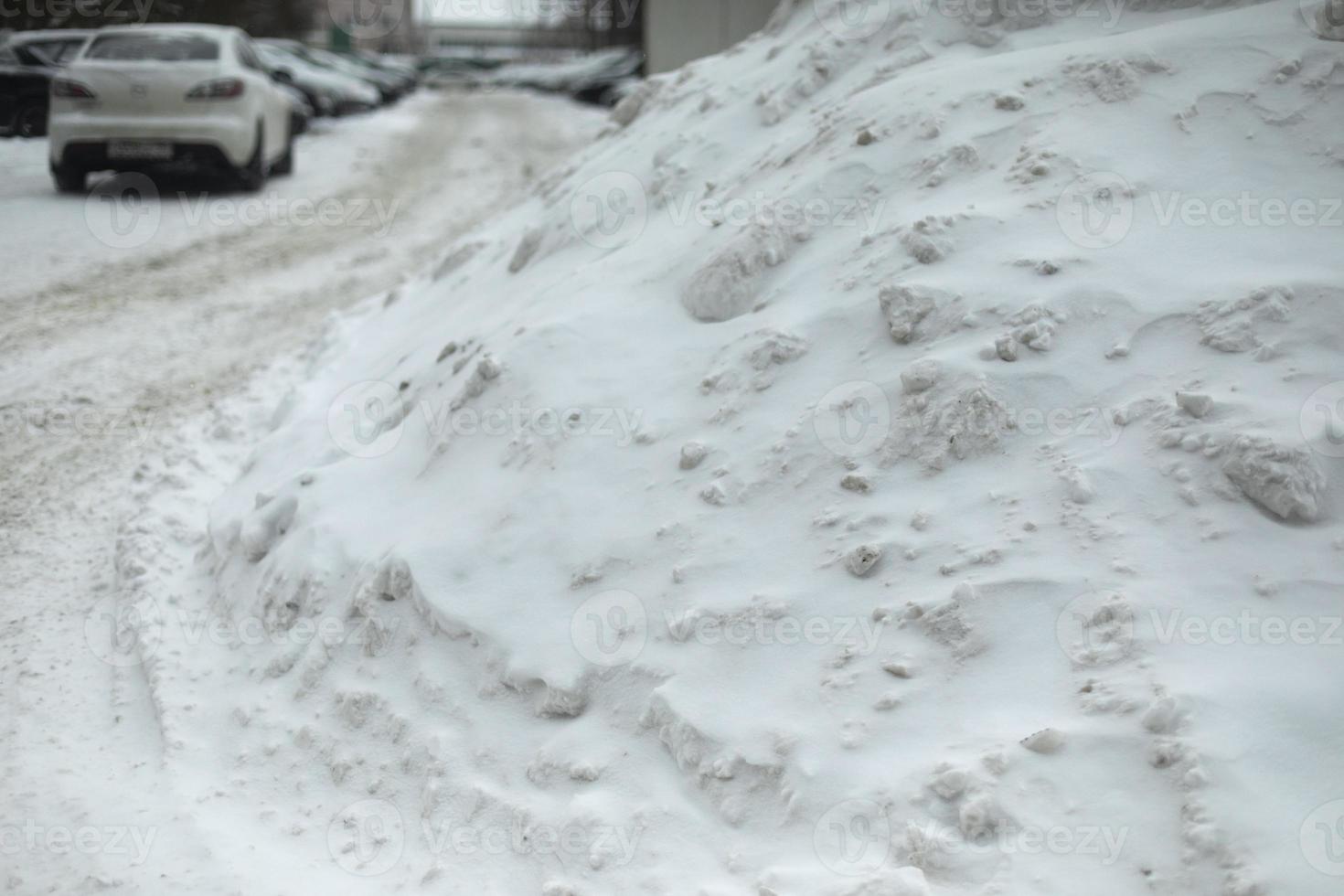 Snow in parking lot. Snowdrift on road. After snowstorm. photo