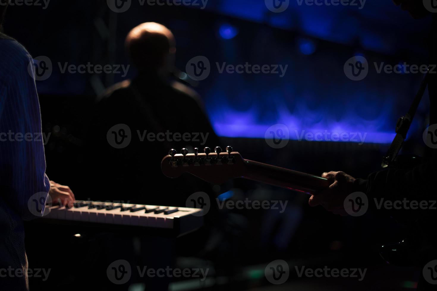 Musicians on stage. Playing musical instruments. Rock band performance. photo