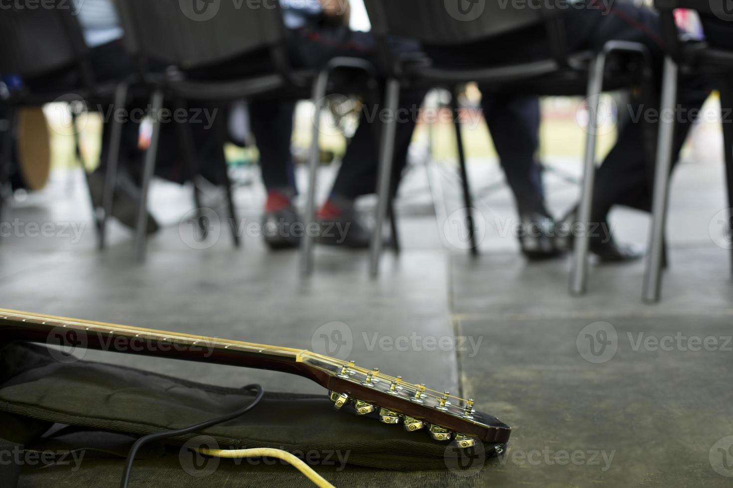 Guitar on stage. Musical instrument at performance. Guitar neck and case. photo