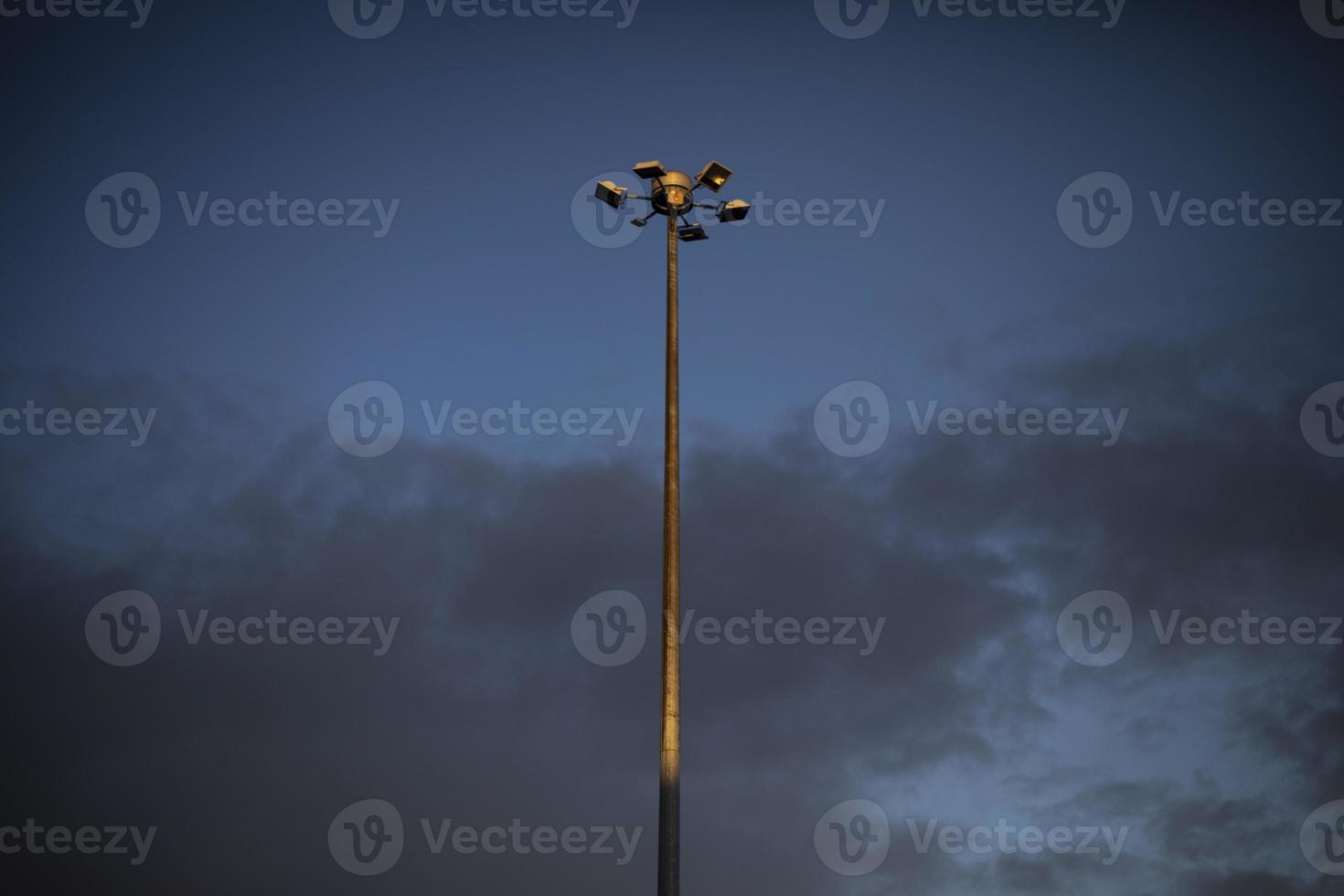 Pillar against sky. Street light in city. Large tower. photo