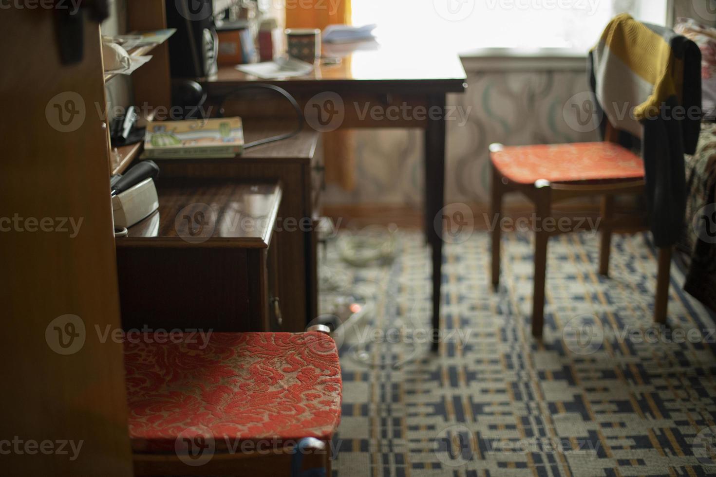 Table and chair. Interior of old apartment in Eastern Europe. Simple interior of house. photo