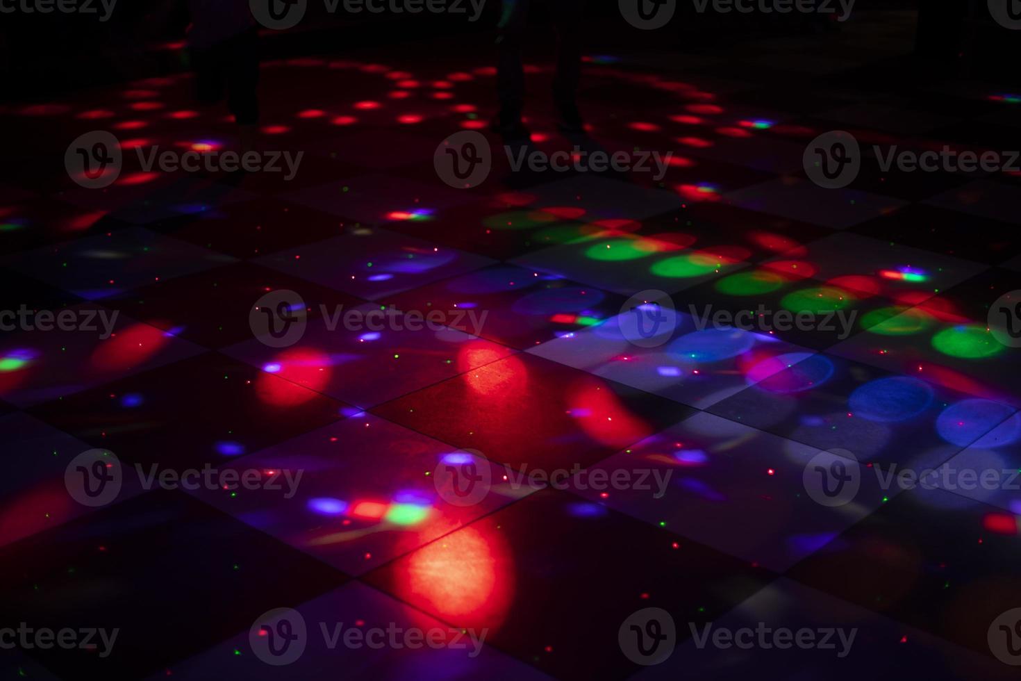 Disco dance floor. Light on dance floor. Colored spots on floor. Lights from spotlight. photo