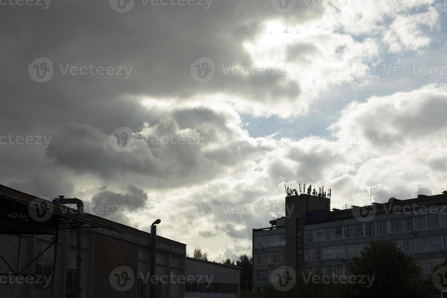 Sky over city. Clouds and buildings. Landscape in summer. photo