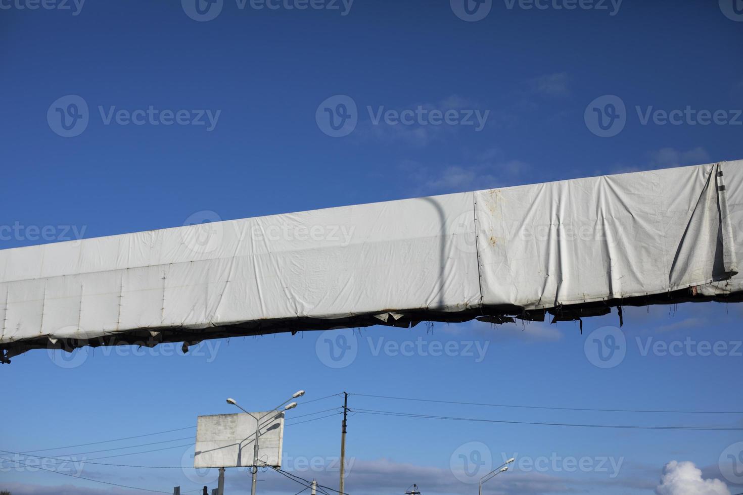 Billboard over road. White billboard above track. Place to place ad. photo