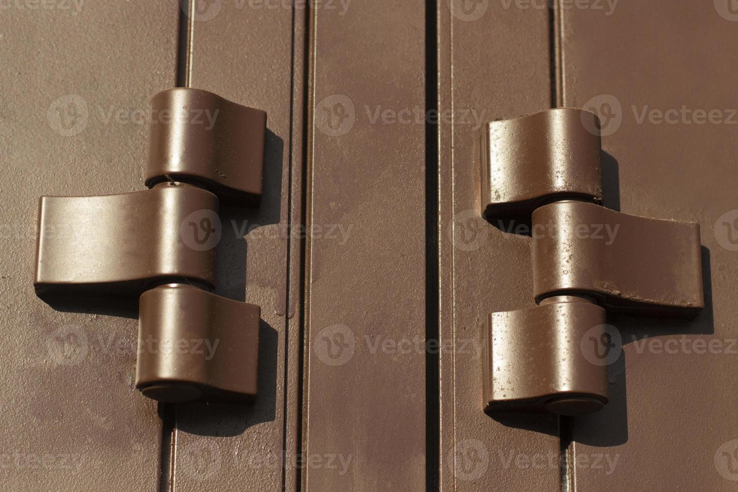 Hinges on door. Brown door hinges. Solid fittings. photo