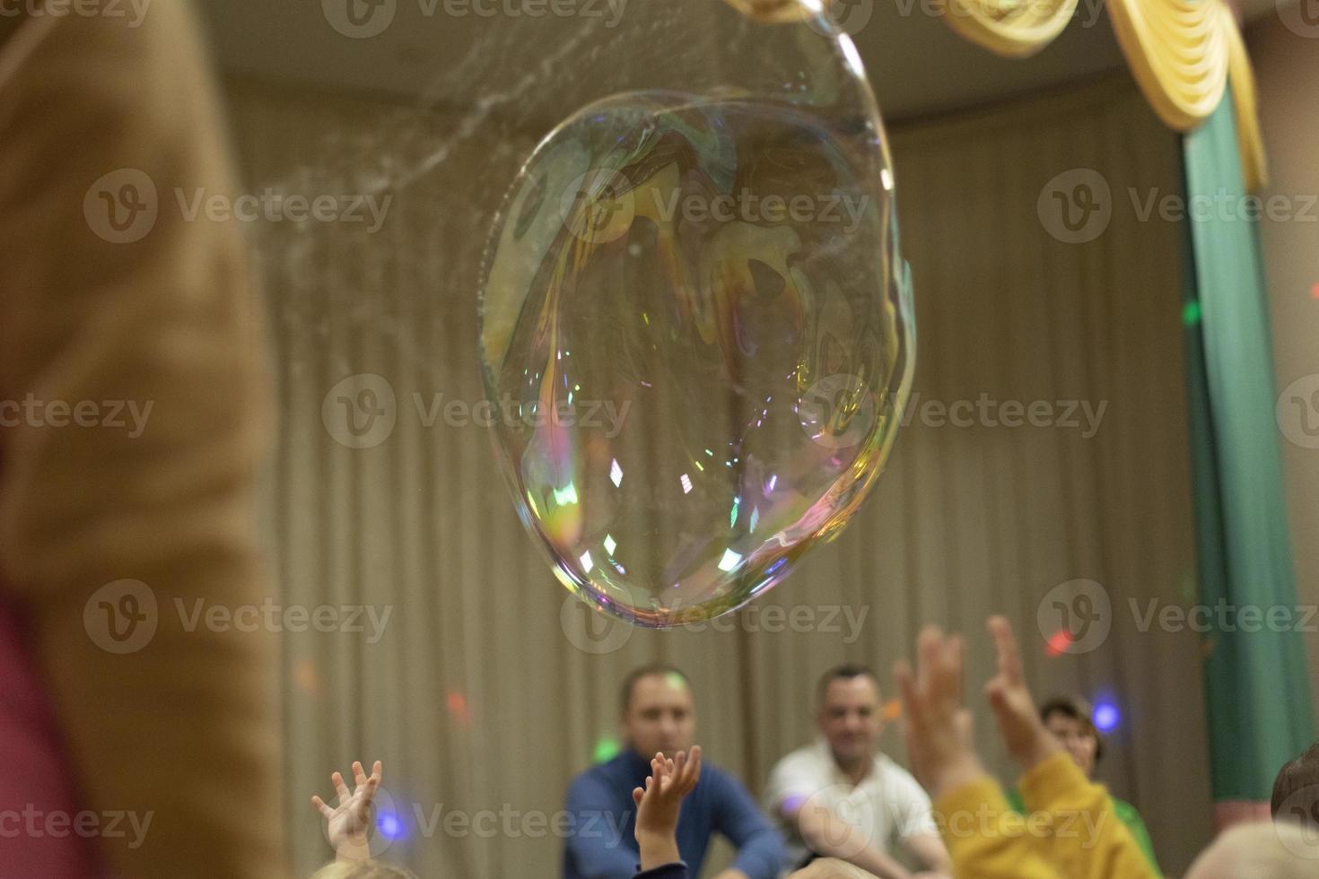 Soap bubble in room. Big bubble. Soapy solution. photo