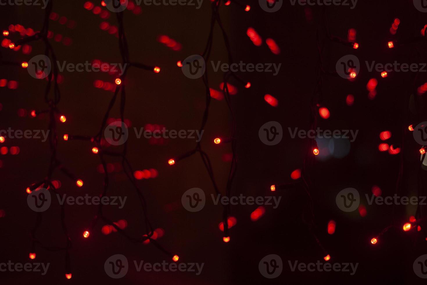 Red dots in space. Lights in dark. Red light bulbs. Lot of small lights in frame. photo