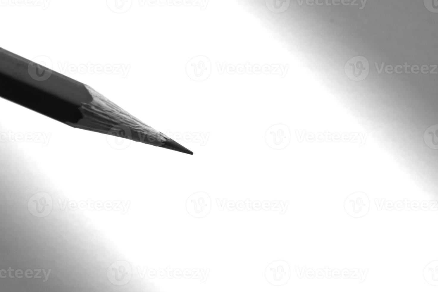 Pencil holding to write on the paper in shadow photo