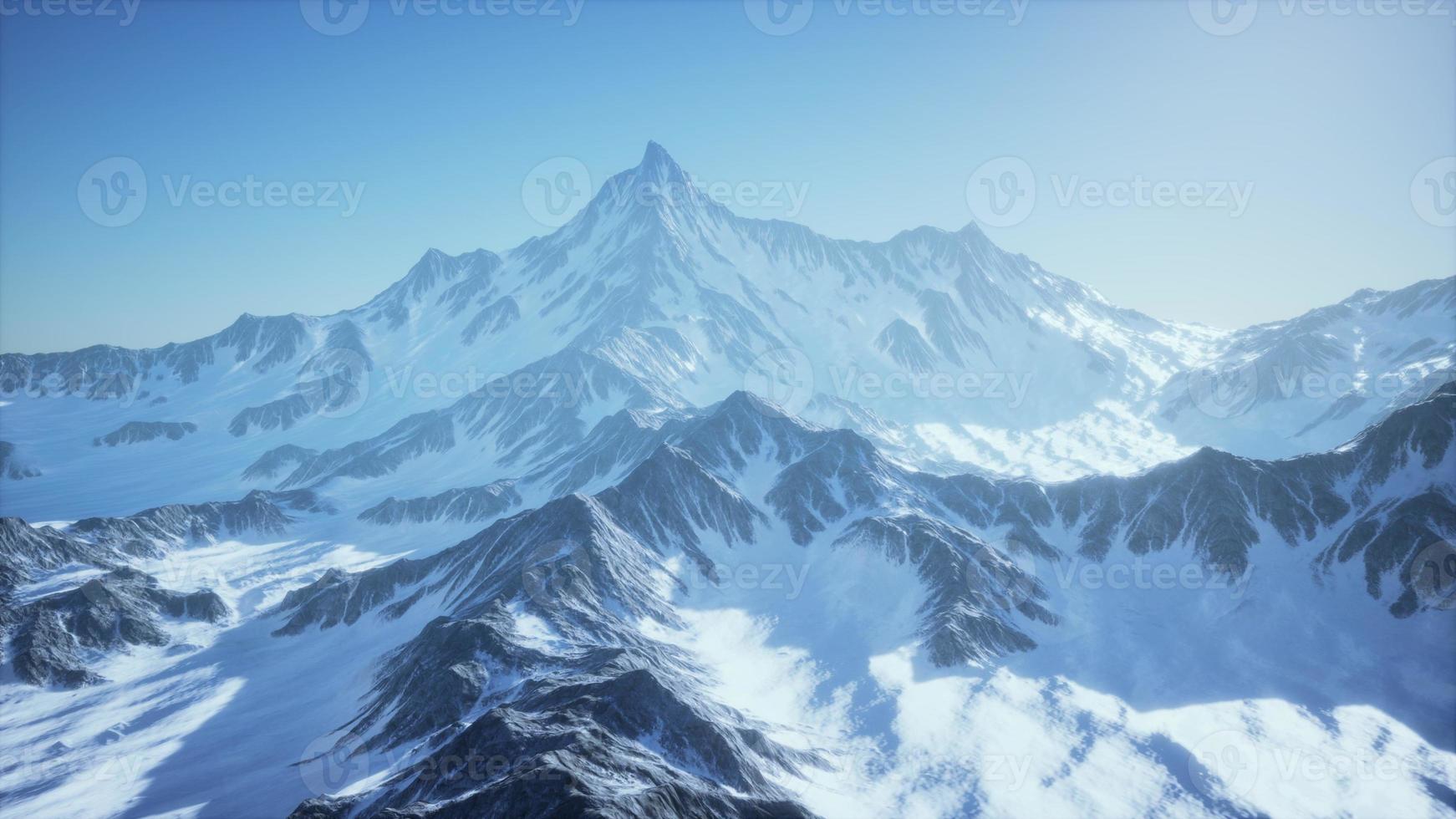 Scenic view on snowy Matterhorn peak in sunny day with blue sky photo